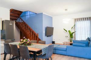 a living room with a table and a blue couch at Rianos in Nafplio