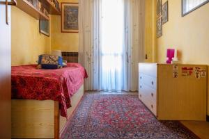 a bedroom with a bed and a dresser and a window at Casa Giulia, Darfo Boario Terme Ospitar in Darfo
