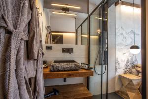 a bathroom with a sink and a shower at WHISPERING PINES LODGE Mountain view apartment with ski-in access in Breuil-Cervinia +41 photos