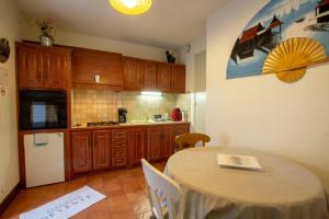 a kitchen with a table and a kitchen with a table and chairs at Gite bironais "studio" in Biron +1 photo