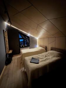 een slaapkamer met 2 bedden in een kamer met een raam bij Mine Hostel Dzhergalan in Dzhergalan