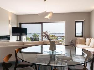 a living room with a glass table and a couch at Soltroia Beach River & Golf in Grândola