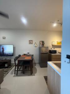 a living room with a table and a kitchen at MMJ Homesuite @ The Shore in Kota Kinabalu +8 photos