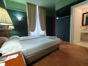 a bedroom with a large bed with a large window at Hotel Nuvò in Naples
