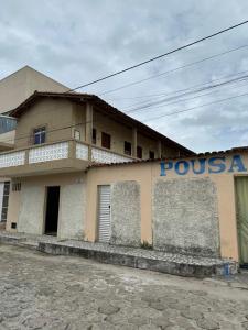 a building with a sign on the side of it at Pousada Alcobaça in Alcobaça