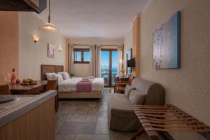 A bed or beds in a room at Agnanti Hotel Apartments