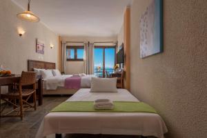 A bed or beds in a room at Agnanti Hotel Apartments