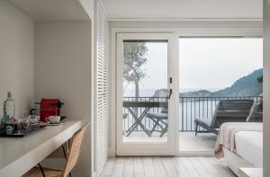 a bedroom with a door leading to a balcony at BYPILLOW Cap Sa Sal in Begur