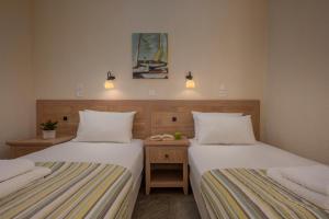 A bed or beds in a room at Agnanti Hotel Apartments