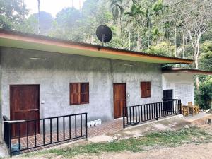 a house with wooden doors on the side of it at Khao Sok Green Mountain View in Khao Sok National Park