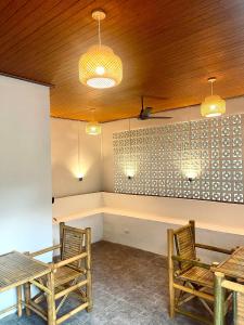 a dining room with two tables and chairs and lights at Khao Sok Green Mountain View in Khao Sok National Park