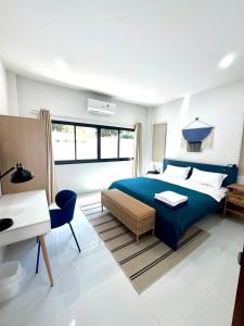 a bedroom with a blue bed and a desk at Luna villa Chaweng Samui in Nathon Bay +19 photos
