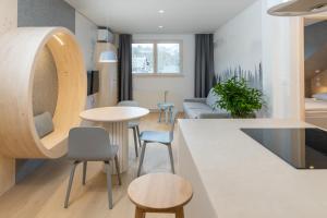 a kitchen and living room with a table and chairs at TD Bohinj Apartments in Bohinj