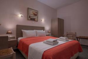 A bed or beds in a room at Agnanti Hotel Apartments