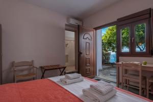 A bed or beds in a room at Agnanti Hotel Apartments