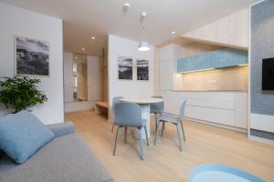a kitchen and dining room with a table and chairs at TD Bohinj Apartments in Bohinj