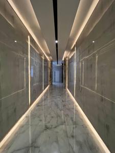 a hallway of a building with marble floors and lights at RIVIERA apartment near complex TSUM and GUM in Bishkek +22 photos