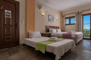 A bed or beds in a room at Agnanti Hotel Apartments