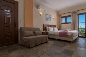 A bed or beds in a room at Agnanti Hotel Apartments