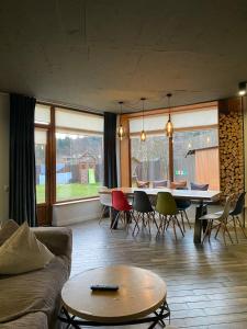 a living room with a couch and a table and chairs at MiShelter in Migovo