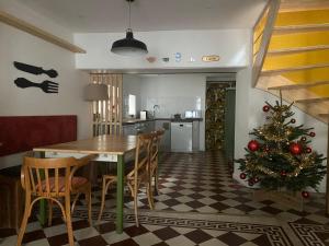 a dining room with a table and a christmas tree at L'Echoppe en ville in Amboise +28 photos
