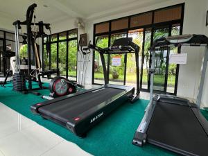 a gym with several tread machines and a treadmill at Luna villa Chaweng Samui in Nathon Bay