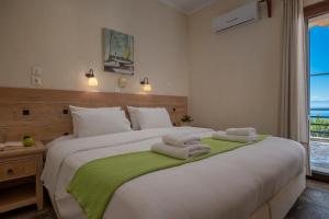 A bed or beds in a room at Agnanti Hotel Apartments
