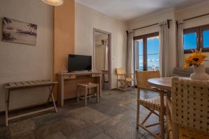 A television and/or entertainment centre at Agnanti Hotel Apartments