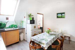 a kitchen with a table with a table cloth on it at MarVen Apartman in Balatonkenese