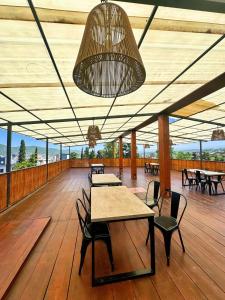 ein Pavillon mit Tischen und Stühlen auf einem Holzboden in der Unterkunft Realty vacacional 61 in Villa Carlos Paz