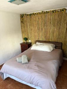 a bedroom with a white bed with a wooden wall at Casa málaga aeropuerto in Málaga