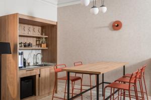 a kitchen with a wooden table and chairs at BYPILLOW Goldoni in Florence