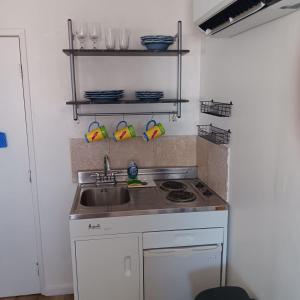a kitchen with a sink and a stove at The Link Vintage Motel #2 Lovely Studio in Lovelock