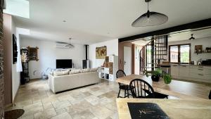 a living room with a couch and a table at Maison de ville cosy in Bergerac