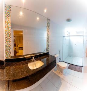 a bathroom with a sink and a toilet and a shower at Hotel Veneza in Itabuna +33 photos