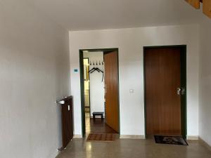 a hallway with two doors and aoyer with a chair at Ferienwohnung Sole Della Sera in Reichersbeuern