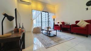 un salon avec un canapé rouge et une table dans l'établissement Nilai Youth City Fully Air-Con Cozy 2 Bedroom HomeStay, à Nilai