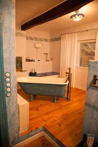 a bathroom with a tub in the middle of a room at La Maison des Roses, mit Pool in Molas