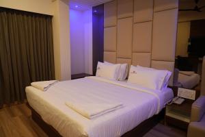 Postel nebo postele na pokoji v ubytování Hotel Grand Sigma