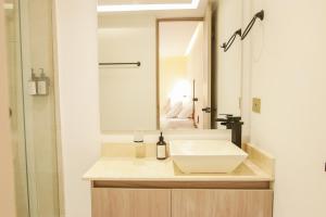 a bathroom with a white sink and a mirror at Dunia Suites Cartagena in Cartagena de Indias