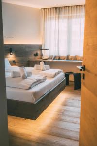 a bedroom with two beds and a large window at LIVALPIN Style in Garmisch-Partenkirchen