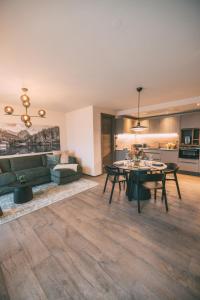 a living room with a couch and a table at LIVALPIN Style in Garmisch-Partenkirchen