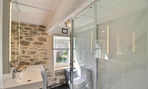 a bathroom with a shower and a sink at Ty Chann Rouz in Ile de Sein +56 photos