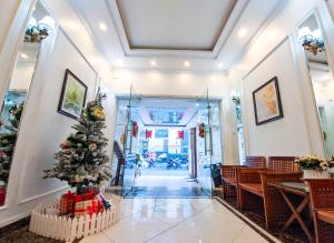 a christmas tree in the hallway of a restaurant at Khách sạn Thế Kỷ Mới in Hanoi