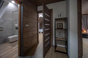 a bathroom with a wooden door and a shower at Domek nad Potokiem 2 in Nowy Targ +40 photos