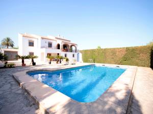 a swimming pool in front of a house at Holiday Home Ximo in Jávea