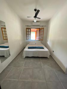 a bedroom with a bed and a ceiling fan at Pousada Chácara Sonho in Hortolândia