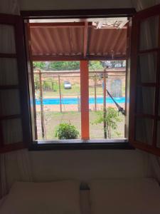 a window in a room with a view of a playground at Pousada Chácara Sonho in Hortolândia