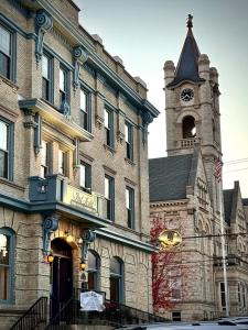 a large brick building with a clock tower at The Port Hotel in Port Washington
