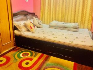 Una cama con almohadas en una habitación. en Blissful Himalayas Home, en Bālāju